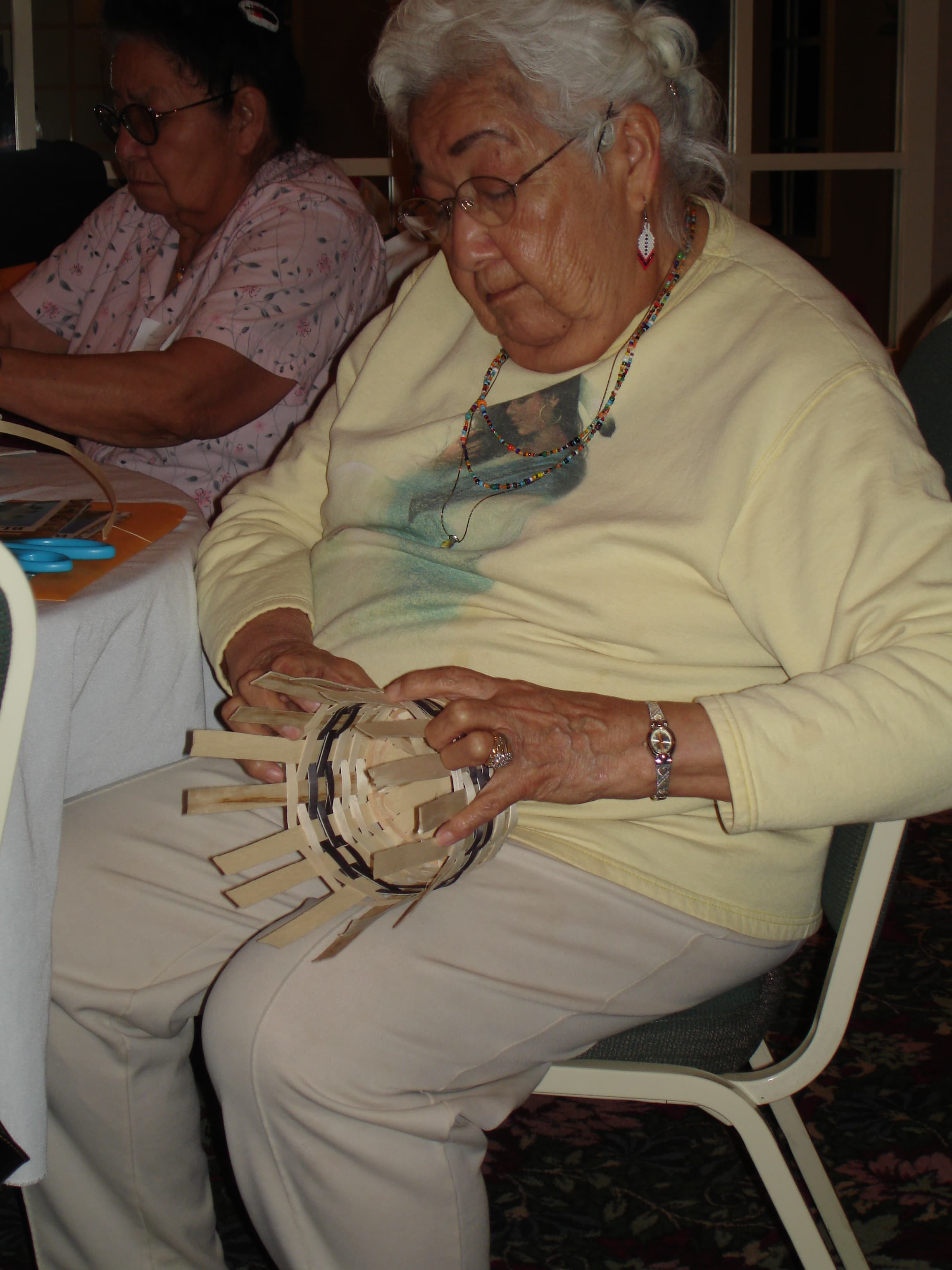 A woman weaving a basket